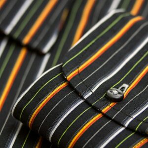 Macro shot showcasing the striped pattern and detailed texture of a men's dress shirt cuff.