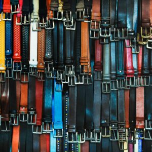 A vibrant assortment of leather belts hanging in a shop in Florence, Italy.
