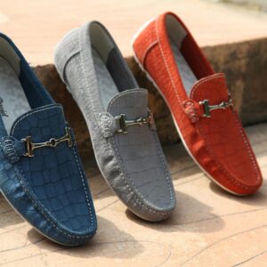 Three colorful leather loafers displayed outdoors showcasing style and elegance.