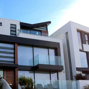 Contemporary luxury home with glass balconies in Poole, UK, showcasing modern architectural design.